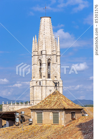 Spain, Catalonia, tower of the Basilica of Sant Feliu in Girona, an old building with a weather vane on the roof. 85301576