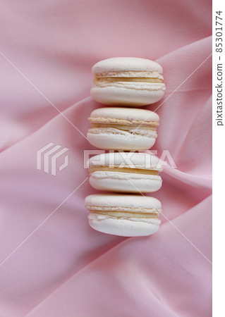 Beige macaron dessert. Pastel french pastry on pink background 85301774