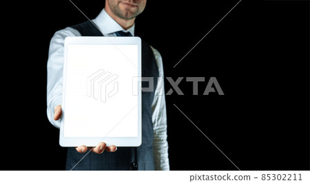 Screen mockup. Empty blank tablet in businessman hand. Mock up screen smart device isolated on black banner background. Game design, mobile application presentation or portfolio mockups. 85302211