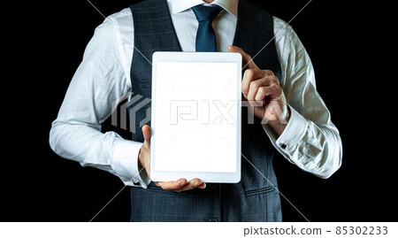 Screen mockup. Empty blank tablet in businessman hand. Mock up screen smart device isolated on black banner background. Game design, mobile application presentation or portfolio mockups. Screen mockup. Empty blank tablet in businessman hand. Mock up screen smart device isolated on black banner background. Game design, mobile application presentation or portfolio mockups. 85302233