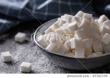 White sugar cubes in a blue bowl on the table White sugar cubes in a blue bowl on the table 85302339
