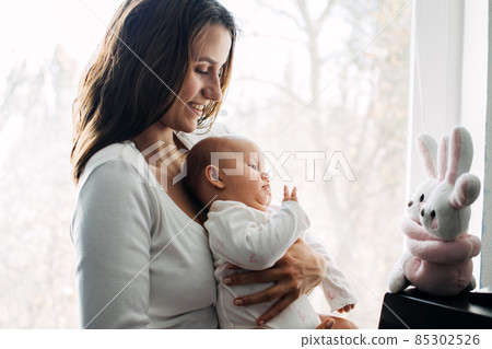 Mental Health in Postpartum Time. Maternal Mental Health. How to avoid pregnancy And Postpartum Disorders, postpartum baby blues, depression. Portrait of happy mother and newborn baby Mental Health in Postpartum Time. Maternal Mental Health. How to avoid pregnancy And Postpartum Disorders, postpartum baby blues, depression. Portrait of happy mother and newborn baby 85302526