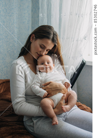Mental Health in Postpartum Time. Maternal Mental Health. How to avoid pregnancy And Postpartum Disorders, postpartum baby blues, depression. Portrait of happy mother and newborn baby Mental Health in Postpartum Time. Maternal Mental Health. How to avoid pregnancy And Postpartum Disorders, postpartum baby blues, depression. Portrait of happy mother and newborn baby 85302746