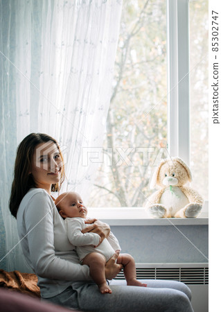 Mental Health in Postpartum Time. Maternal Mental Health. How to avoid pregnancy And Postpartum Disorders, postpartum baby blues, depression. Portrait of happy mother and newborn baby Mental Health in Postpartum Time. Maternal Mental Health. How to avoid pregnancy And Postpartum Disorders, postpartum baby blues, depression. Portrait of happy mother and newborn baby 85302747