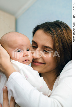 Mental Health in Postpartum Time. Maternal Mental Health. How to avoid pregnancy And Postpartum Disorders, postpartum baby blues, depression. Portrait of happy mother and newborn baby Mental Health in Postpartum Time. Maternal Mental Health. How to avoid pregnancy And Postpartum Disorders, postpartum baby blues, depression. Portrait of happy mother and newborn baby 85302748