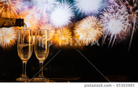 two champagne glasses against fireworks  New Year's eve celebration 85303985