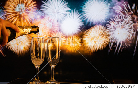 two champagne glasses against fireworks  New Year's eve celebration 85303987