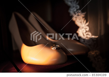 Bride's shoes, gold rings. Morning of the bride. Wedding details Bride's shoes, gold rings. Morning of the bride. Wedding details 85304109
