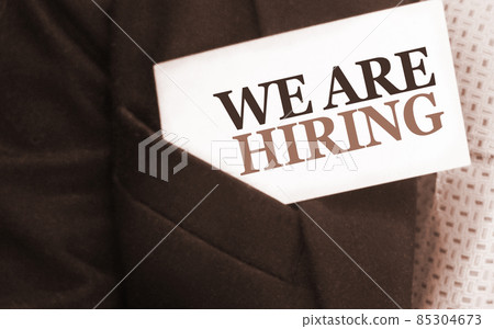 We are Hiring words on a card in upper businessman pocket. Selective focus. Business management concept 85304673