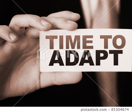 Time To Adapt on a card in businessman had. Business crisis management concept 85304674