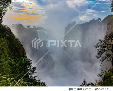 Victoria Falls with water dust and fog in the morning at sunrise 85304839