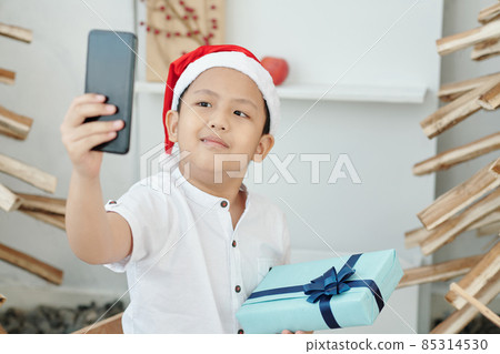 Boy in Santa Hat Taking Selfie 85314530