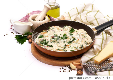 Delicious small meatballs with spinach in a creamy sauce in the frying pan Delicious small meatballs with spinach in a creamy sauce in the frying pan 85315913