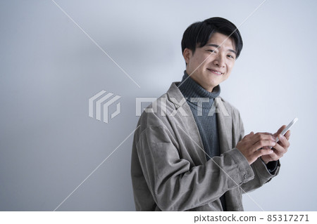 A man using a smartphone A man using a smartphone 85317271
