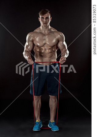 Young athletic man exercising and doing fitness 85319073