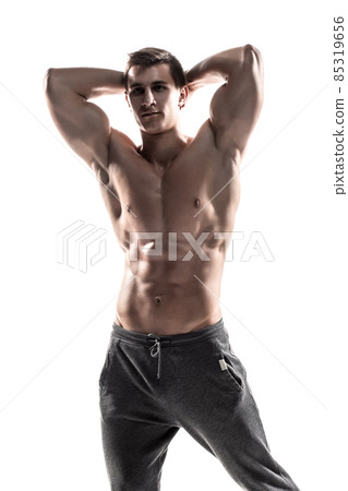 Muscular man posing, flexing his biceps, showing perfect body. Muscular man posing, flexing his biceps, showing perfect body. 85319656