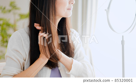 Senior female doing hair care 85320001