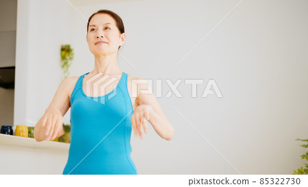 Senior female stretching at home Senior female stretching at home 85322730