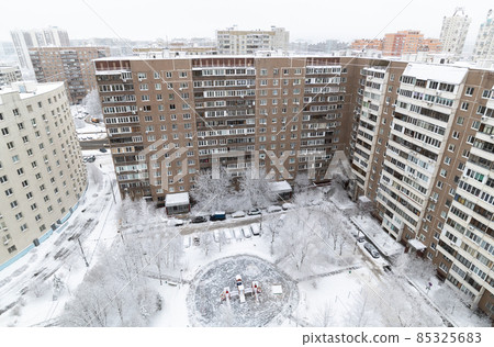 Yard with children's playground during heavy snow in Russia. Top view Yard with children's playground during heavy snow in Russia. Top view 85325683
