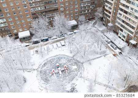 Yard with children's playground during heavy snow in Russia. Top view Yard with children's playground during heavy snow in Russia. Top view 85325684