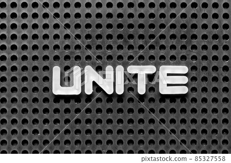 White alphabet letter in word unite on black pegboard background White alphabet letter in word unite on black pegboard background 85327558
