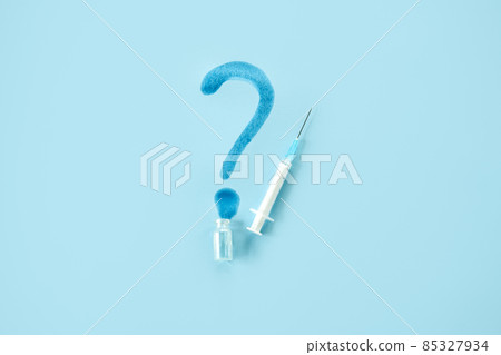 Expired COVID vaccines concept. Spoiled expired wasted vaccine doses. Vaccine Storage and Handling. Spilled medicine vial bottle and syringe on blue background 85327934
