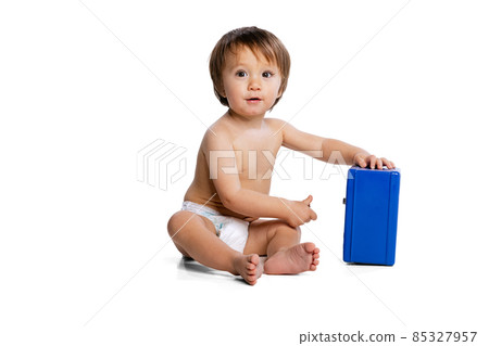 Portrait of little boy, baby, child in diaper playing with toy safe box isolated over white studio background. Childhood concept 85327957