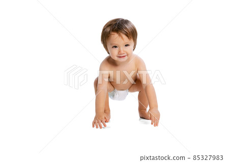 Portrait of little boy, baby, child in diaper posing isolated over white studio background. Childhood concept 85327983
