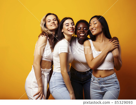 diverse multi nation girls group, teenage friends company cheerful having fun, happy smiling, cute posing on yellow background, lifestyle people concept, african-american, asian and caucasian diverse multi nation girls group, teenage friends company cheerful having fun, happy smiling, cute posing on yellow background, lifestyle people concept, african-american, asian and caucasian 85329093