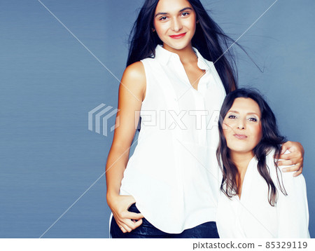 cute pretty teen daughter with mature mother hugging, fashion style brunette, lifestyle people concept cute pretty teen daughter with mature mother hugging, fashion style brunette, lifestyle people concept 85329119