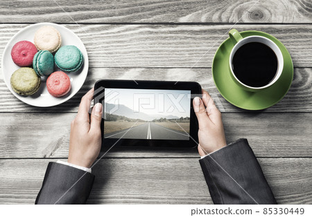 Businesswoman having coffee break Businesswoman having coffee break 85330449