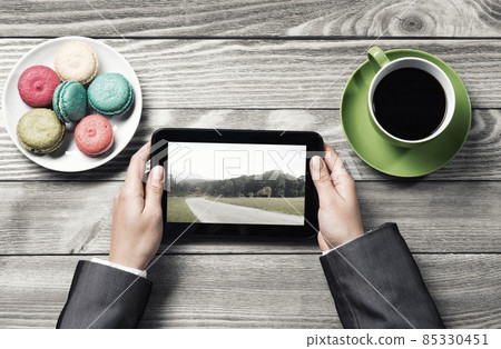 Businesswoman having coffee break Businesswoman having coffee break 85330451