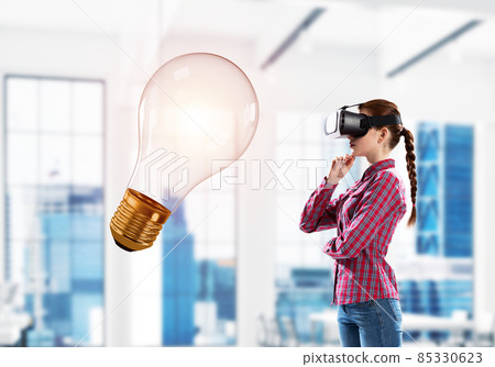 Girl in virtual reality mask experiencing virtual technology world. Mixed media Girl in virtual reality mask experiencing virtual technology world. Mixed media 85330623