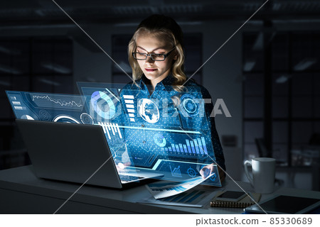 Beautiful blonde working on laptop and infographs out of screen. Mixed media Beautiful blonde working on laptop and infographs out of screen. Mixed media 85330689