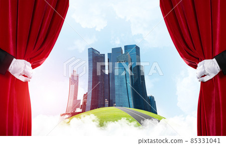 Modern cityscape behind drapery curtain and hand opening it 85331041