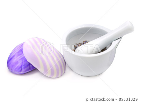 Lavender soap and dry lavender flowers in a mortar isolated on a white . Lavender soap and dry lavender flowers in a mortar isolated on a white . 85331329