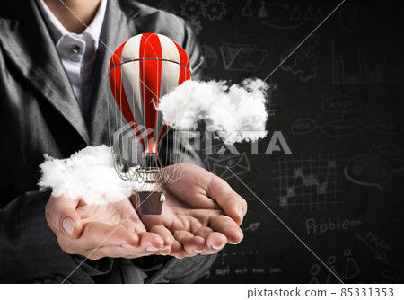 Woman presenting flying balloon in hand. Woman presenting flying balloon in hand. 85331353