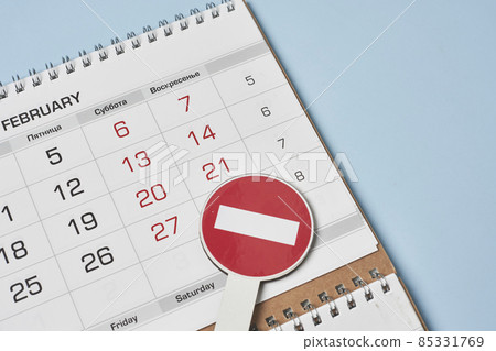 Close-up view of monthly calendar and No entry traffic sign. Symbol of cancellation, forbidding and banning. Symbol of quarantine or lockdown. Banned vacation, quarantine restrictions Close-up view of monthly calendar and No entry traffic sign. Symbol of cancellation, forbidding and banning. Symbol of quarantine or lockdown. Banned vacation, quarantine restrictions 85331769