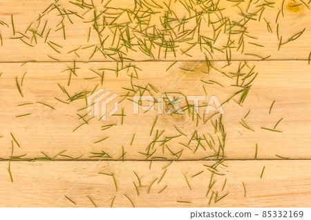 New Year's green spruce with crumbling needles on wooden background. End of the new year and holidays concept 85332169