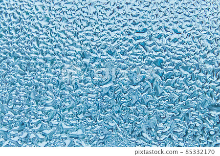 Cold blue water drops on glass window texture, winter background Cold blue water drops on glass window texture, winter background 85332170