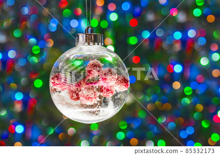 Christmas decorative ball on blurred multicolored bokeh background Christmas decorative ball on blurred multicolored bokeh background 85332173