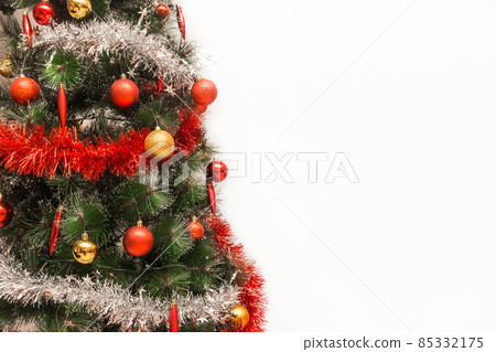 Christmas tree decorated with garlands and tinsel and white background copy space or mock up Christmas tree decorated with garlands and tinsel and white background copy space or mock up 85332175