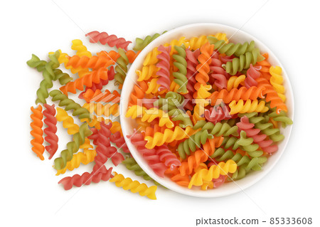 raw Fusilli colored pasta in ceramic bowl isolated on white background with clipping path and full depth of field. Top view. Flat lay 85333608