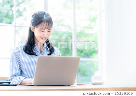 A beautiful Japanese woman who works on a computer while looking down, which is easy to use for the main visual 3 85339109