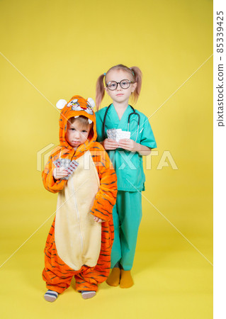 children play doctor, a boy in a tiger costume came to the pediatrician children play doctor, a boy in a tiger costume came to the pediatrician 85339425