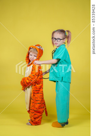 children play doctor, a boy in a tiger costume came to the pediatrician children play doctor, a boy in a tiger costume came to the pediatrician 85339428