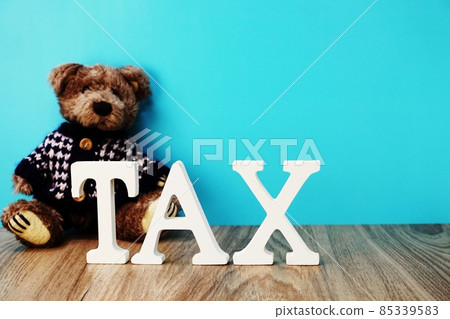 teddy bear and tax alphabet letters on wooden background teddy bear and tax alphabet letters on wooden background 85339583