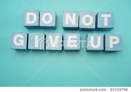 Do Not Give Up word made from wooden cubes with letters alphabet on blue background 85339796