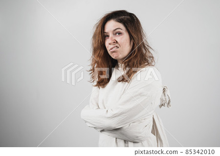 Close-up portrait of insane woman in straitjacket on white background. 85342010