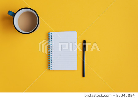 Note pad and marker on yellow background 85343884